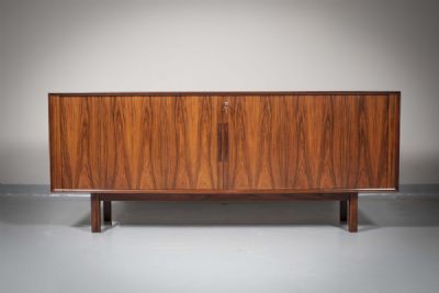 A ROSEWOOD SIDEBOARD by Arne Vodder  at deVeres Auctions