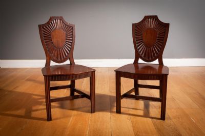 A PAIR OF GEORGIAN MAHOGANY HALL CHAIRS at deVeres Auctions