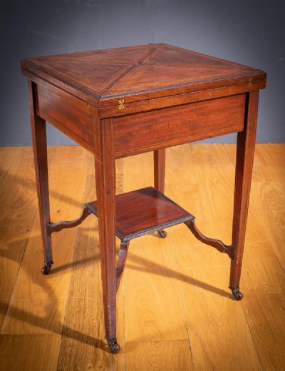 A MAHOGANY AND SATINWOOD AND EBONY INLAID CARD ENVELOPE CARD TABLE at deVeres Auctions