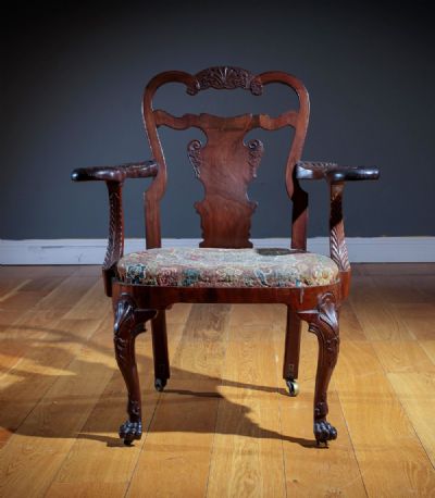 AN IRISH MAHOGANY AND WALNUT OPEN ARMCHAIR, 19th C at deVeres Auctions