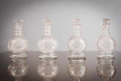 A SET OF FOUR CUT GLASS DECANTERS at deVeres Auctions