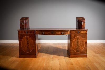 A MAHOGANY, ROSEWOOD CROSSBANDED, SATINWOOD AND BOXWOOD INLAID BOW FRONTED SIDEBOARD at deVeres Auctions