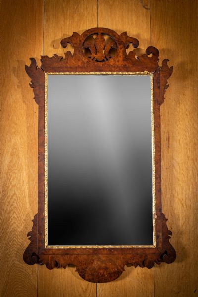 A GEORGIAN MAHOGANY AND PARCEL GILT WALL MIRROR at deVeres Auctions