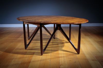 A FINE ROSEWOOD OVAL DROP LEAF DINING TABLE, DANIS at deVeres Auctions