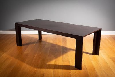 A LARGE DARKWOOD DINING TABLE by LOMI DESIGN  at deVeres Auctions