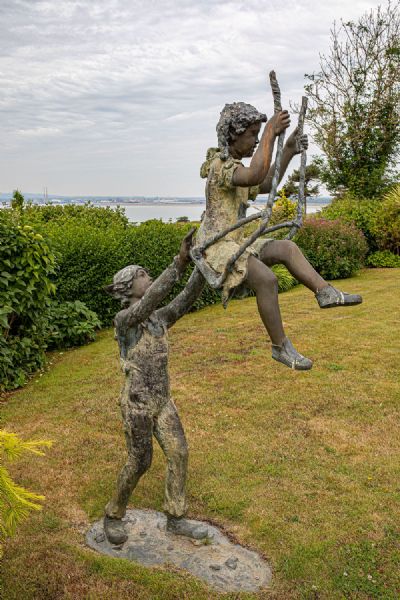 A LARGE CAST METAL STATUE OF CHILDREN AT PLAY, at deVeres Auctions