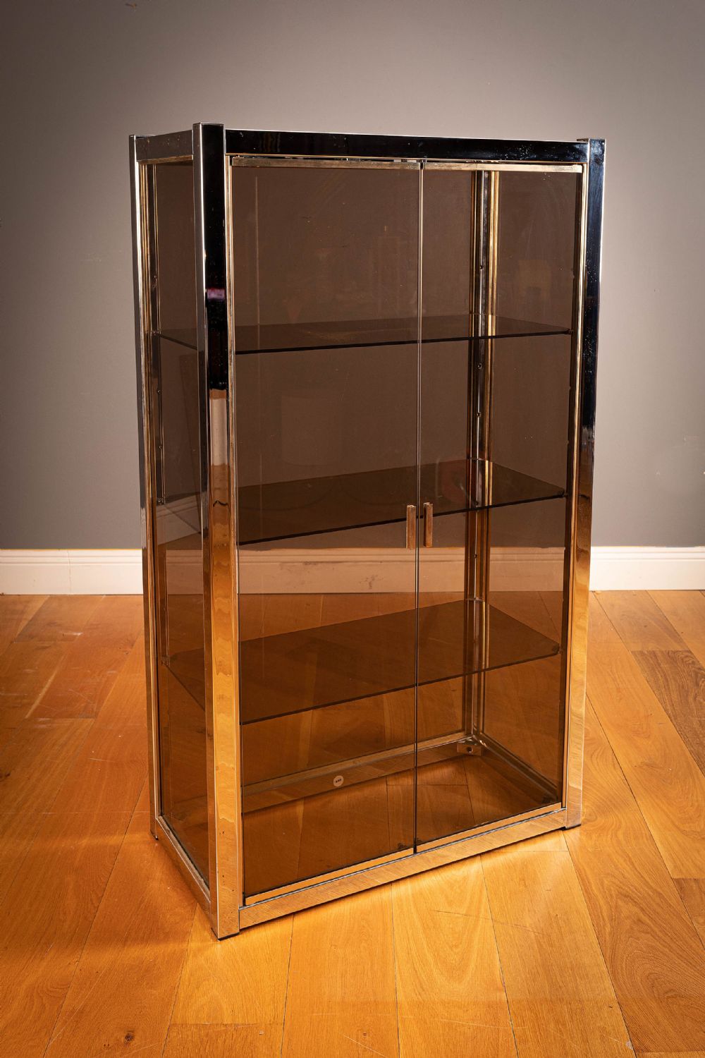 A CHROME AND GILT METAL CABINET, 1970s