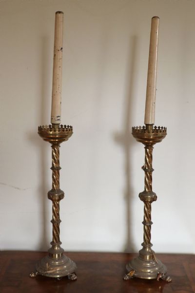 177 by A PAIR OF BRASS CANDLESTICKS  at deVeres Auctions