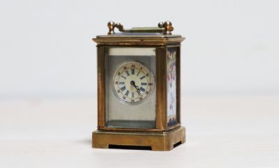 297 by A MINIATURE CARRIAGE CLOCK  at deVeres Auctions