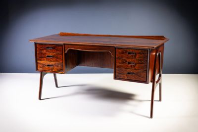 A ROSEWOOD DESK by Svend Aage Madsen  at deVeres Auctions