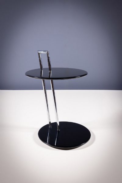 AN EILEEN GRAY BLACK ROUND SIDE TABLE by Eileen Gray  at deVeres Auctions